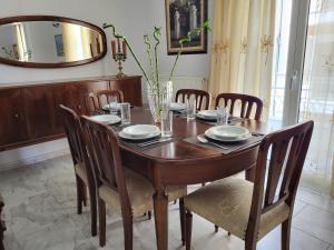 a dining room table with chairs and a mirror at Rêve in Zakynthos