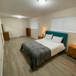 a bedroom with a large bed with a blue headboard at House in Thousand Oaks in Thousand Oaks