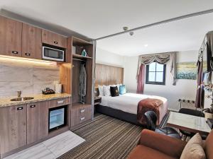 a hotel room with a bed and a bathroom at The Salisbury Business Class in Christchurch
