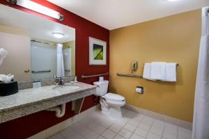 a bathroom with a toilet and a sink at Sonesta Select Dallas Richardson in Richardson