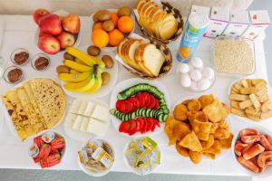 a table with many different types of food on it at Villa Abedini in Ksamil