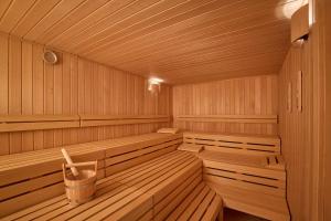 a wooden sauna with benches and a trash can at Adina Apartment Hotel Geneva in Geneva