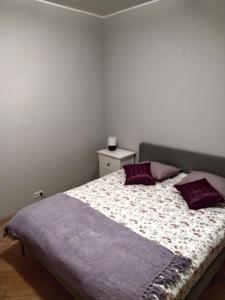 una camera da letto con letto e cuscini viola di ToTuToTam a Varsavia