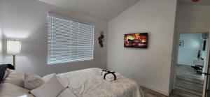 a white room with a bed and a window at Luxury family-friendly 2BR Home near downtown SD in National City