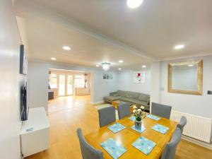 a dining room and living room with a table and chairs at Three bedrooms house in Windsor in Windsor +5 photos