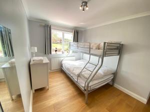 a bedroom with a bunk bed in a room at Three bedrooms house in Windsor in Windsor