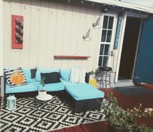 a patio with a blue couch on a deck at sunshine in St Petersburg