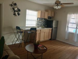 a kitchen with a small table and a kitchen with a refrigerator at sunshine in St. Petersburg