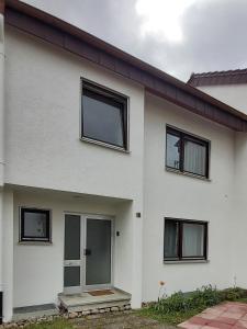 a white house with black windows at Stilvolles Haus 124 qm in Balingen