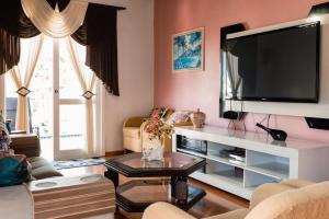 a living room with a large flat screen tv at Casa da bela Vista in Gramado