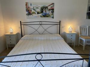 a bedroom with a large bed with two night stands at Masseria Caliani in Borgagne