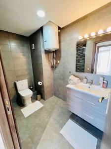 a bathroom with a sink and a toilet at DreamParc - Vue sur Mer et Parc Securite 24H in Mohammedia