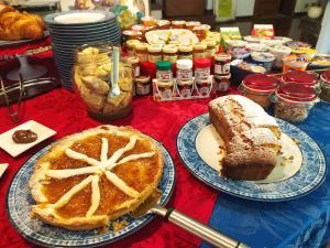 a table with two plates of pie and other desserts at B&B Cà d'Artisti in Caorle