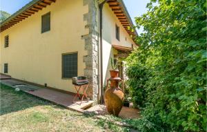 a large vase sitting in front of a house at Cozy Apartment In Molino Del Piano in Molino del Piano +36 photos