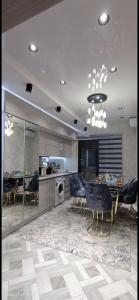a kitchen with a table and chairs and a dining room at Luxury Apartment in the Center 6 in Tashkent