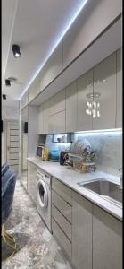 a kitchen with a sink and a washing machine at Luxury Apartment in the Center 6 in Tashkent