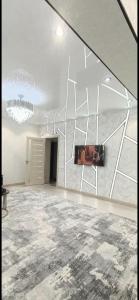 a large room with a chandelier and a wall at Luxury Apartment in the Center 6 in Tashkent