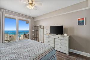 a bedroom with a bed and a flat screen tv at Sea-Renity at Laketown Wharf #1607 by Nautical Properties in Panama City Beach
