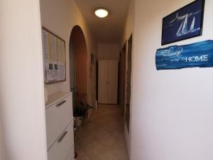 a hallway in a building with a sign on the wall at Apartment Punat 5378b in Punat