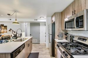 a kitchen with a sink and a stove at Convenient - Near Hospitals - King Bed in Salt Lake City