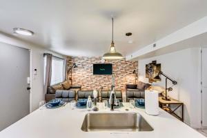 a kitchen with a sink and a living room at Convenient - Near Hospitals - King Bed in Salt Lake City