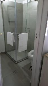 a bathroom with a glass shower stall with a toilet at Hostal La Cestería Pueblito Boyacense in Duitama