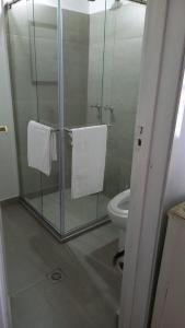 a bathroom with a glass shower with a toilet at Hostal La Cestería Pueblito Boyacense in Duitama