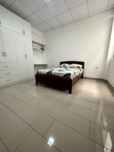 a bedroom with a bed and a tiled floor at Alojamiento increíble!! in Iquitos