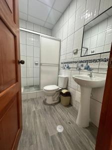 a bathroom with a toilet and a sink at Alojamiento increíble!! in Iquitos