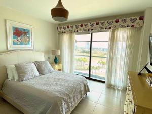 a bedroom with a bed and a large window at Disfruta hermosa vista al mar! in San Carlos