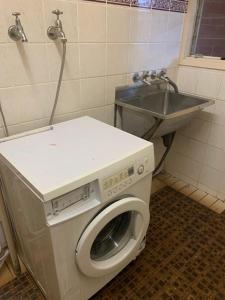 a washing machine in a bathroom with a sink at Corio (Geelong) Holiday Villa in Corio