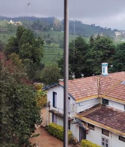 a view of a house in a village at Belair cottages in Kotagiri