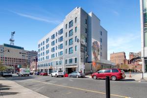 a city street with cars parked in front of a building at Rhythm & Blues Free Park 2BD-2BTH Near EWR-Penn-Prudential in Newark