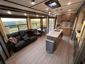 a living room and kitchen of an rv at Temecula Hilltop View Glamping Next To Wineries in Temecula