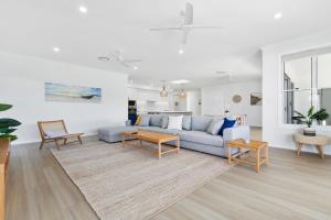a living room with a couch and a table at Osprey Oasis in Banksia Beach