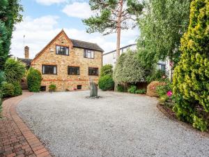 a house with a gravel driveway in front of it at Riverside 4 Bedroom House Wraysbury Staines in Wraysbury