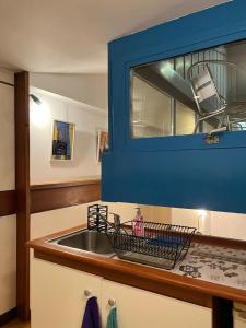 a kitchen with a sink and a blue cabinet at La Serra Olivetti in Ivrea