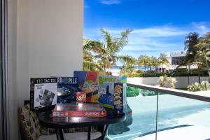 a table with books on a balcony with a view of the ocean at Breathtaking Beach Condo!!! in Hollywood