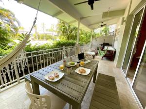 a wooden table with plates of food on a balcony at Next to Puntarena Beach Club! - Amazing Balcony - Sleeps 6 in Boca de Río Hato
