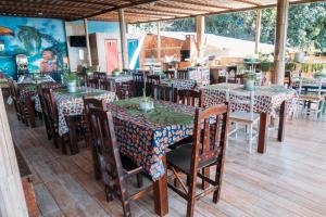 a restaurant with tables and chairs in a room at Pousada Morango das Palmas in Praia de Palmas +49 photos