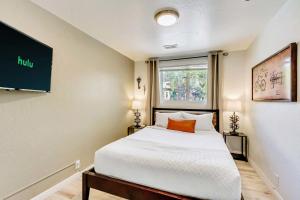 a small bedroom with a bed and a window at One Mile Convention - Quiet Top Floor - Fast Wi-Fi in Salt Lake City