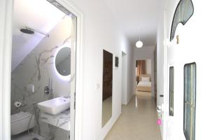a white bathroom with a sink and a mirror at Seaside Villa Genti Seaview in Ksamil +68 photos