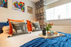 a bed with a tray of food on it at iStay Here Ltd - Luxury 1 Bed with Wifi, Sky, Parking - African Adventure in Aston End