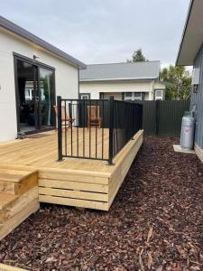 a wooden deck in front of a house at Affordable Modern Accommodation in Westport