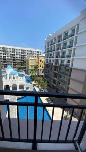 a balcony with a view of a pool and buildings at Arcadia Beach Continental in Pattaya South