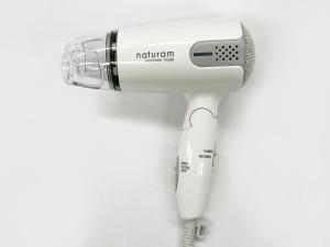 a white hairdryer on a white wall at Route Inn Grantia Akita Spa Resort in Akita
