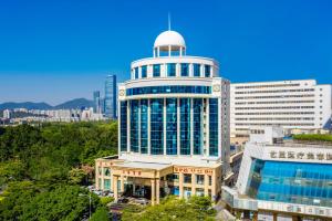 a large building with a dome on top of it at Shenzhen Shanghai Hotel -Complimentary Mini Bar and Late Check Out in Shenzhen