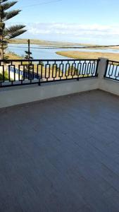 a balcony with a fence and a view of the ocean at New apartment with water view in El Jadida