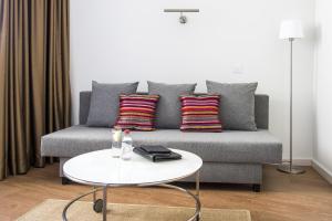 a living room with a couch and a table at Hotel Londres Estoril / Cascais in Estoril