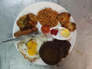 a plate of breakfast food with eggs potatoes and beans at NALDUM VILLAGE RESORT By The Edge Nagarkot in Nagarkot